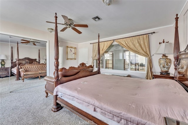 carpeted bedroom with crown molding, ceiling fan, and a closet