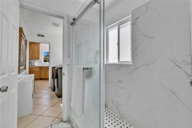 bathroom with a tile shower and vanity