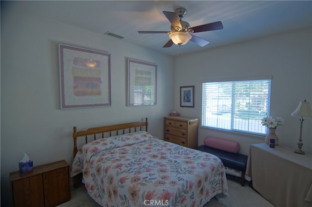 bedroom with light carpet and ceiling fan