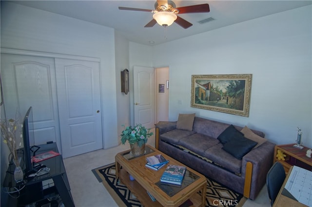 carpeted living room featuring ceiling fan