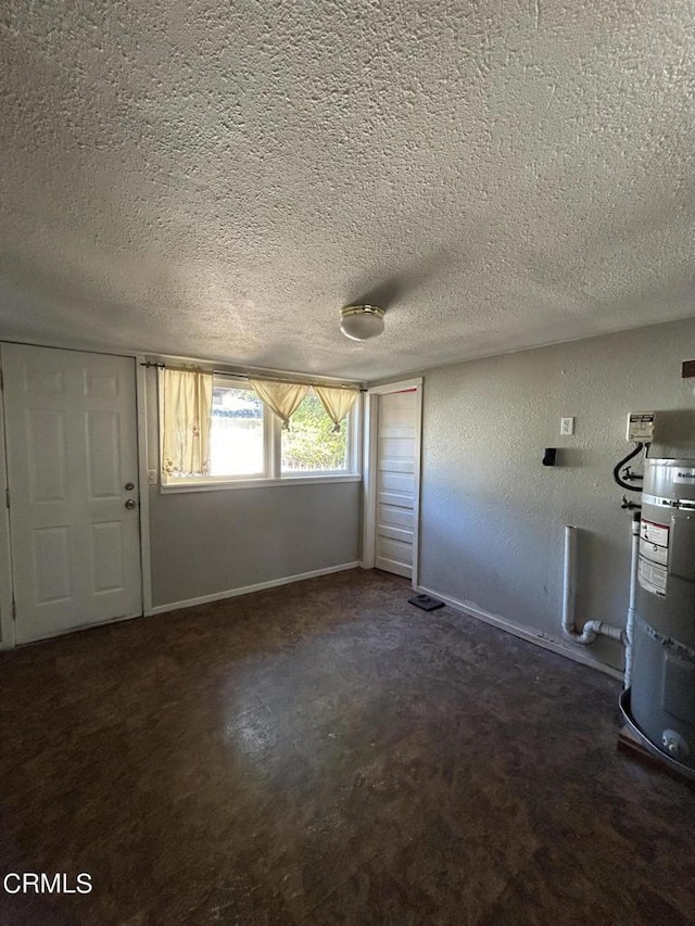 entrance foyer with water heater and a textured ceiling