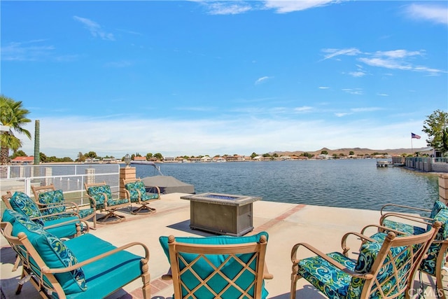 view of patio / terrace with a water view and a fire pit