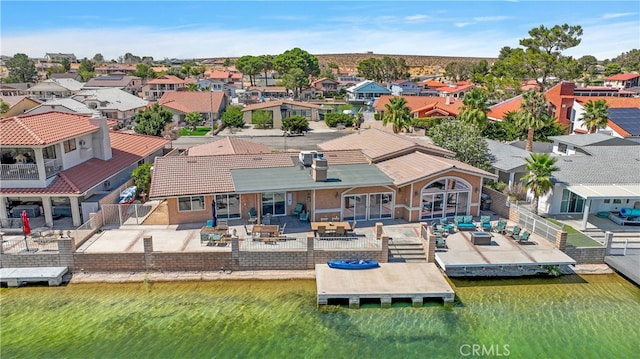 drone / aerial view with a residential view and a water view