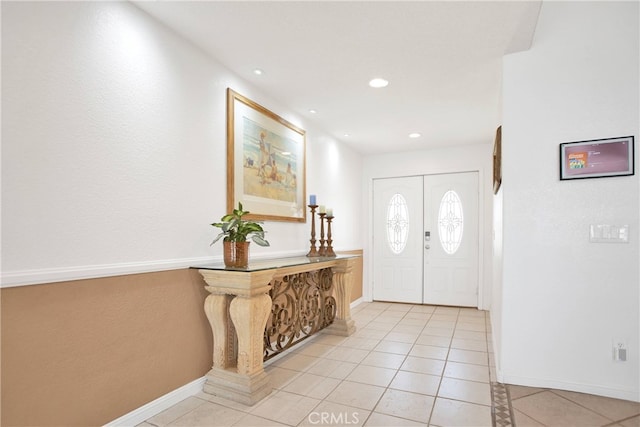 foyer entrance with light tile patterned floors, recessed lighting, and baseboards