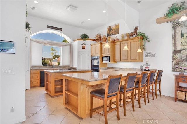 kitchen with visible vents, dobule oven black, open shelves, stainless steel microwave, and a peninsula