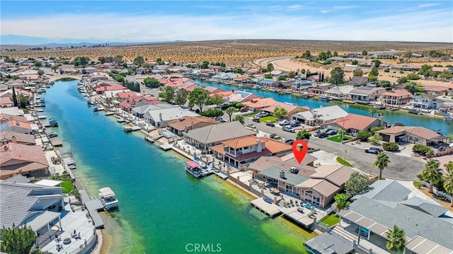 drone / aerial view featuring a residential view and a water view