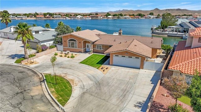 drone / aerial view with a water and mountain view