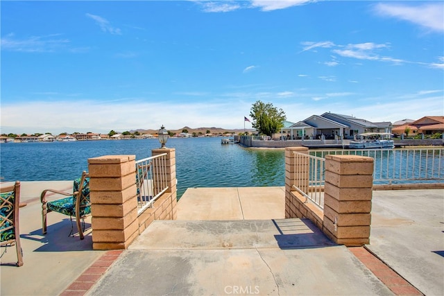 dock area featuring a residential view and a water view