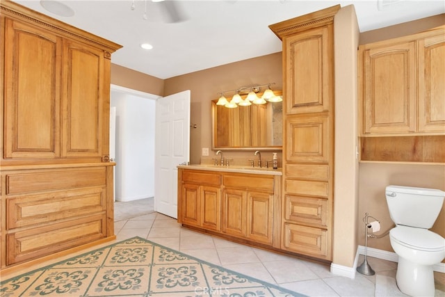 bathroom featuring vanity, a ceiling fan, baseboards, tile patterned floors, and toilet