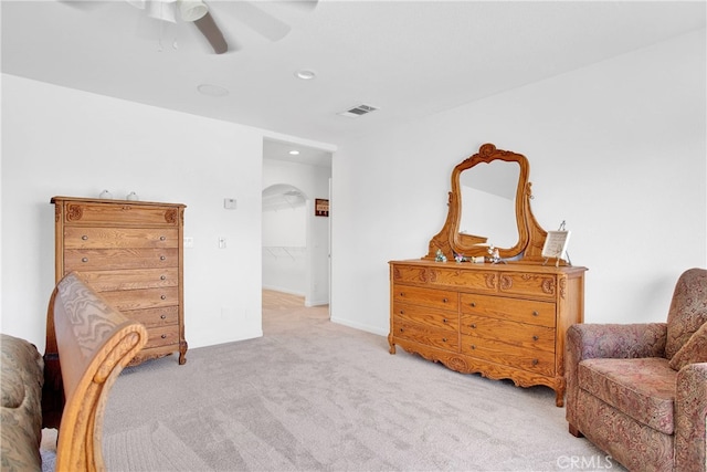 living area with light carpet and ceiling fan