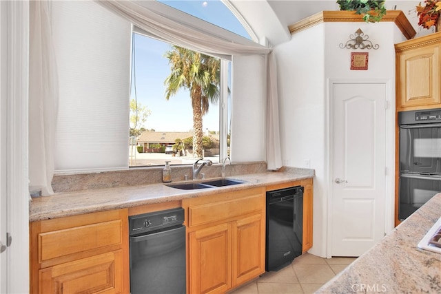 kitchen with a sink, light tile patterned floors, light stone countertops, and dobule oven black