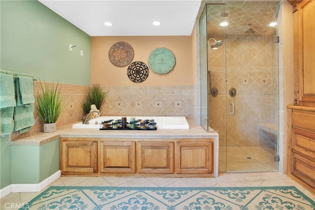 bathroom with tile patterned floors, a garden tub, and a shower stall