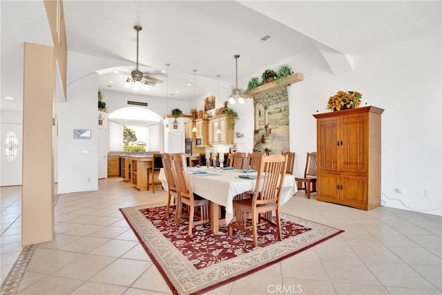 tiled dining space featuring ceiling fan