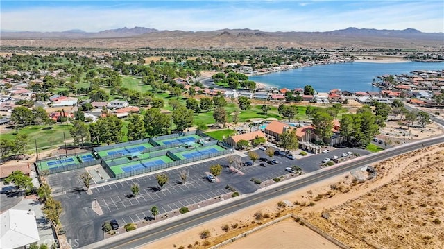 birds eye view of property with a water and mountain view