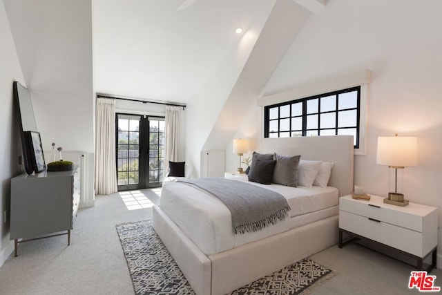 bedroom featuring high vaulted ceiling, access to outside, light colored carpet, and french doors