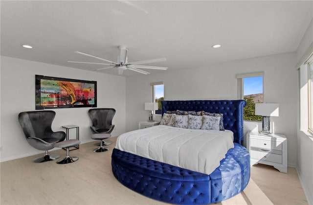 bedroom with ceiling fan and light hardwood / wood-style flooring