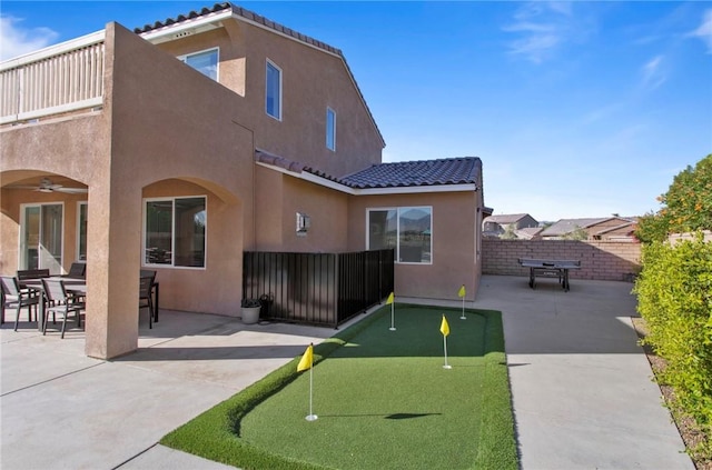 back of house with a patio area and ceiling fan