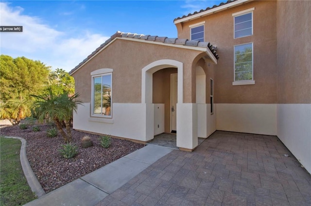 entrance to property featuring a patio area