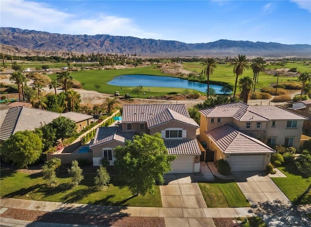 birds eye view of property with a water and mountain view