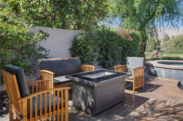 view of patio / terrace with an outdoor fire pit and an outdoor hot tub