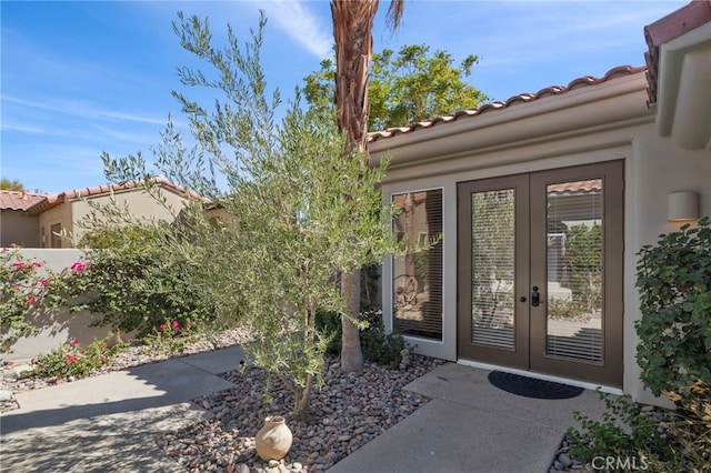 view of exterior entry featuring french doors