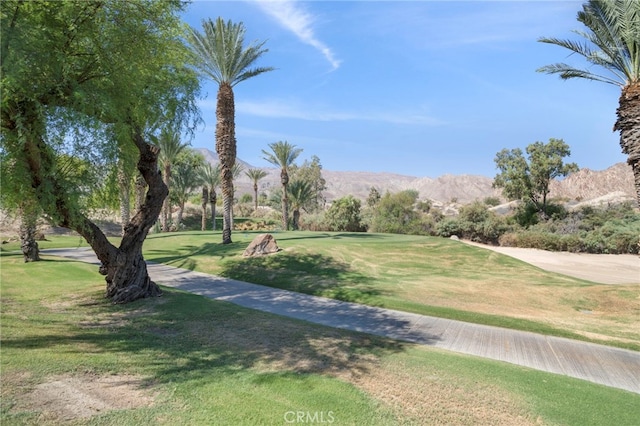 surrounding community with a mountain view and a yard