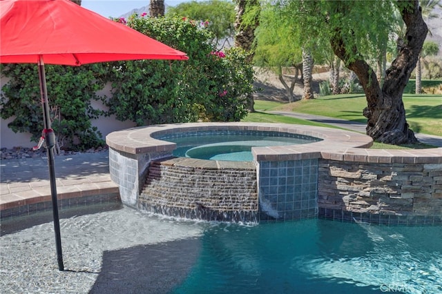 view of swimming pool with an in ground hot tub