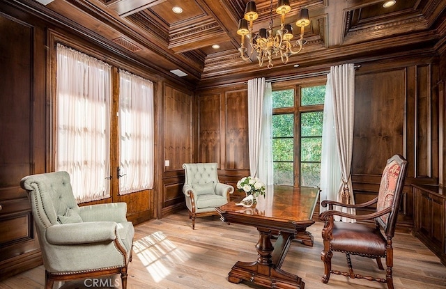 sitting room featuring beam ceiling, light hardwood / wood-style floors, coffered ceiling, wooden walls, and crown molding