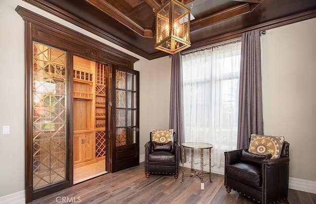 living area with ornamental molding and hardwood / wood-style flooring