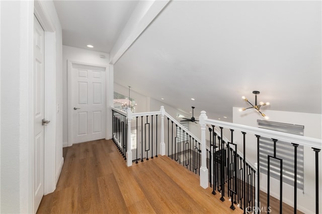 hallway with a notable chandelier and wood-type flooring