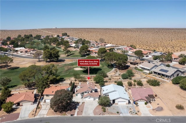 aerial view featuring view of desert and a residential view
