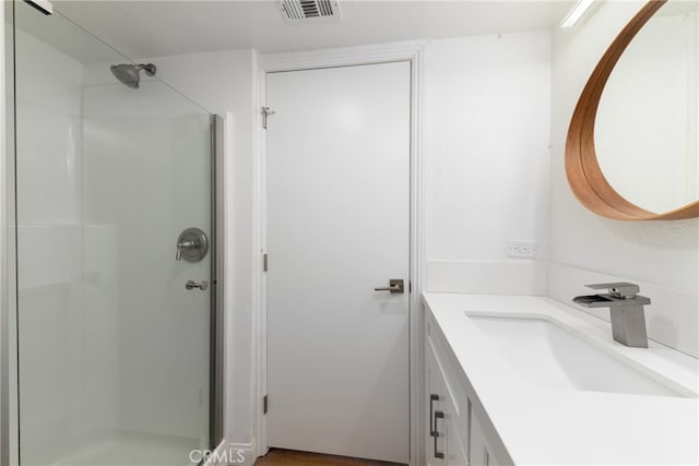 bathroom featuring an enclosed shower and vanity