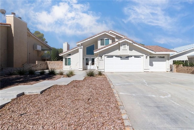 view of front of home with fence, a garage, and concrete driveway