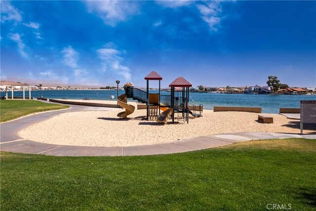 view of jungle gym featuring a lawn and a water view