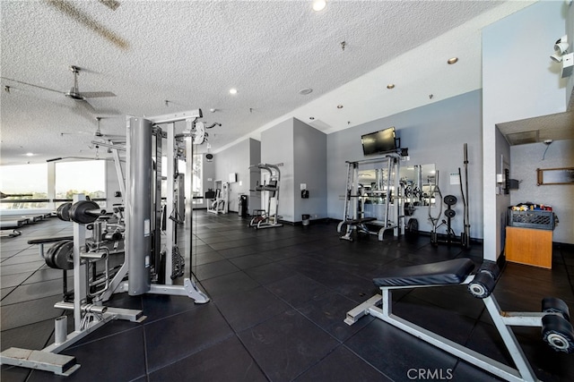 gym featuring a textured ceiling and ceiling fan