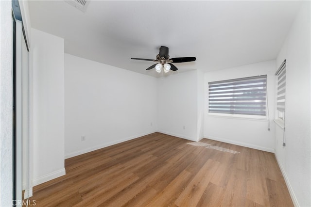 empty room with ceiling fan and hardwood / wood-style flooring