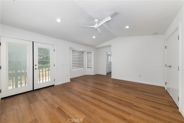 interior space featuring light hardwood / wood-style flooring, vaulted ceiling, ceiling fan, and french doors