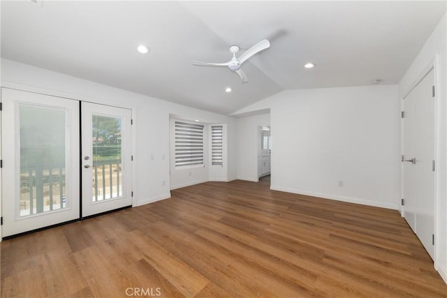 unfurnished bedroom featuring light wood-style floors, access to outside, vaulted ceiling, and recessed lighting