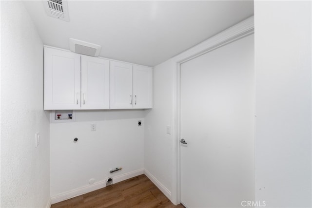 laundry room with hookup for an electric dryer, hookup for a gas dryer, cabinets, hookup for a washing machine, and dark hardwood / wood-style flooring