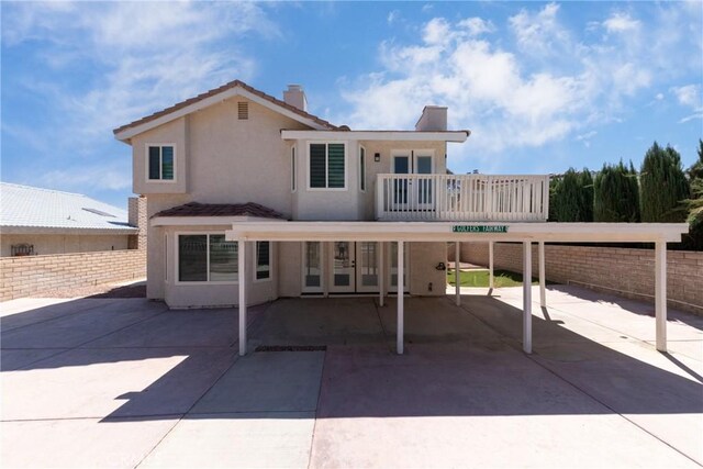 back of house featuring a balcony