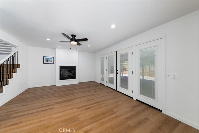 unfurnished living room with light hardwood / wood-style floors and ceiling fan