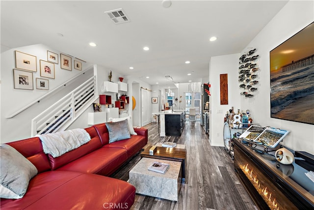 living room with sink and dark hardwood / wood-style flooring