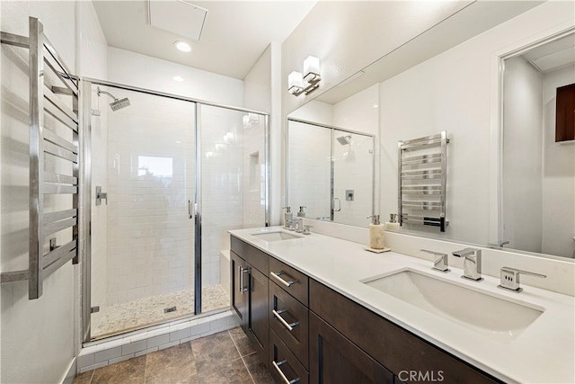 bathroom featuring radiator, an enclosed shower, and vanity