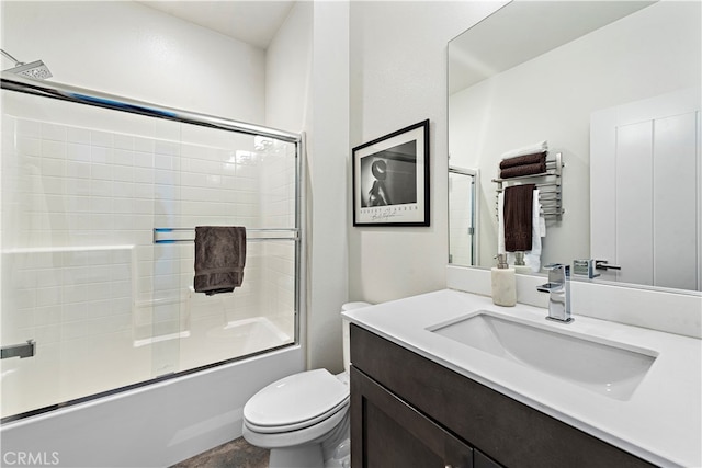 full bathroom with vanity, toilet, and combined bath / shower with glass door