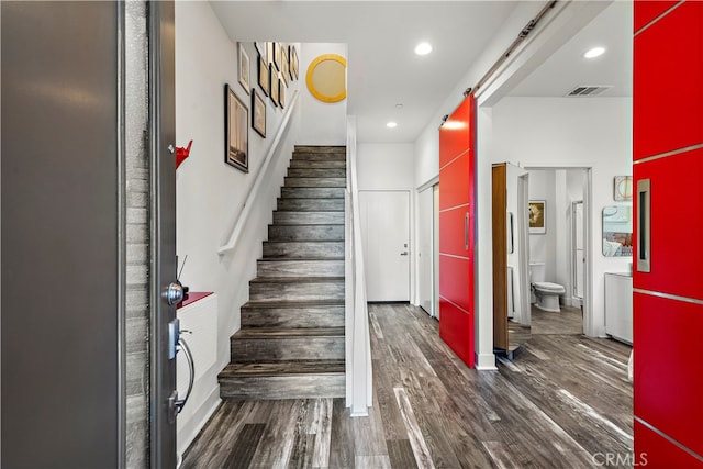 stairs featuring wood-type flooring