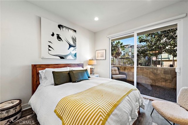 bedroom featuring access to exterior and dark hardwood / wood-style flooring