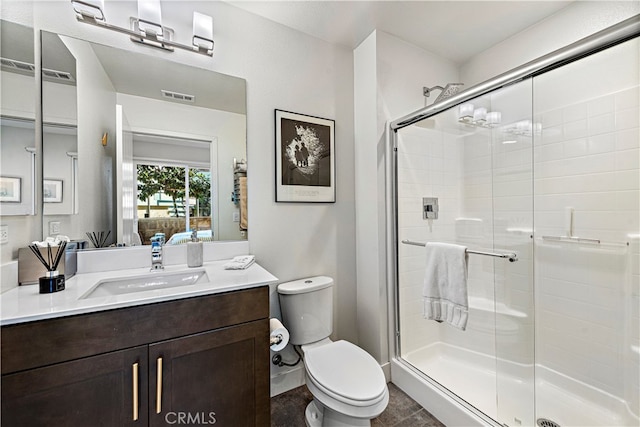 bathroom featuring walk in shower, vanity, and toilet