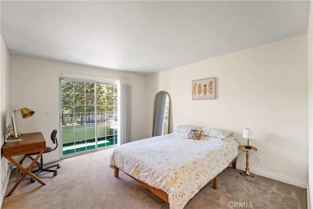 carpeted bedroom featuring access to exterior