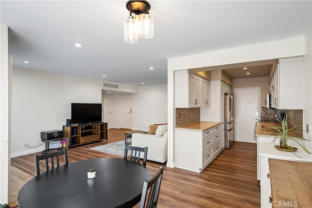 dining area featuring dark wood-type flooring