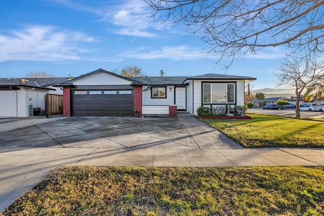 single story home featuring a garage and a front lawn